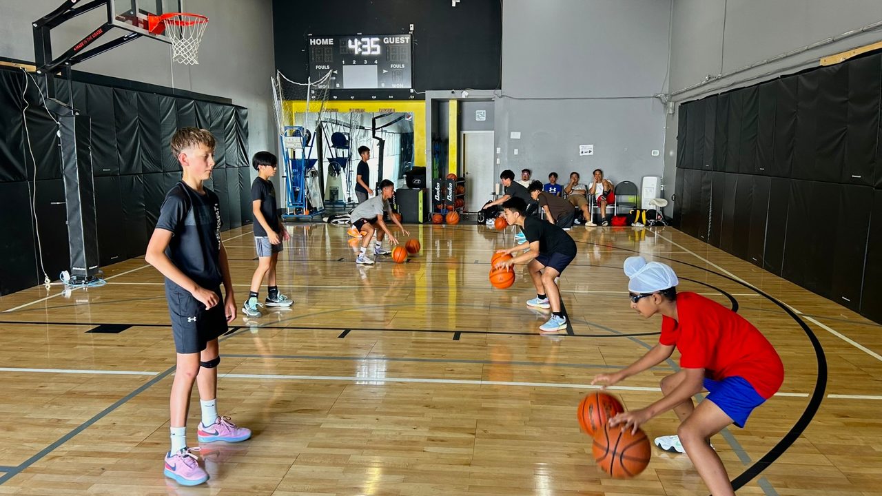 Small group of youth players working through dribbling drills at Legacy Basketball Club