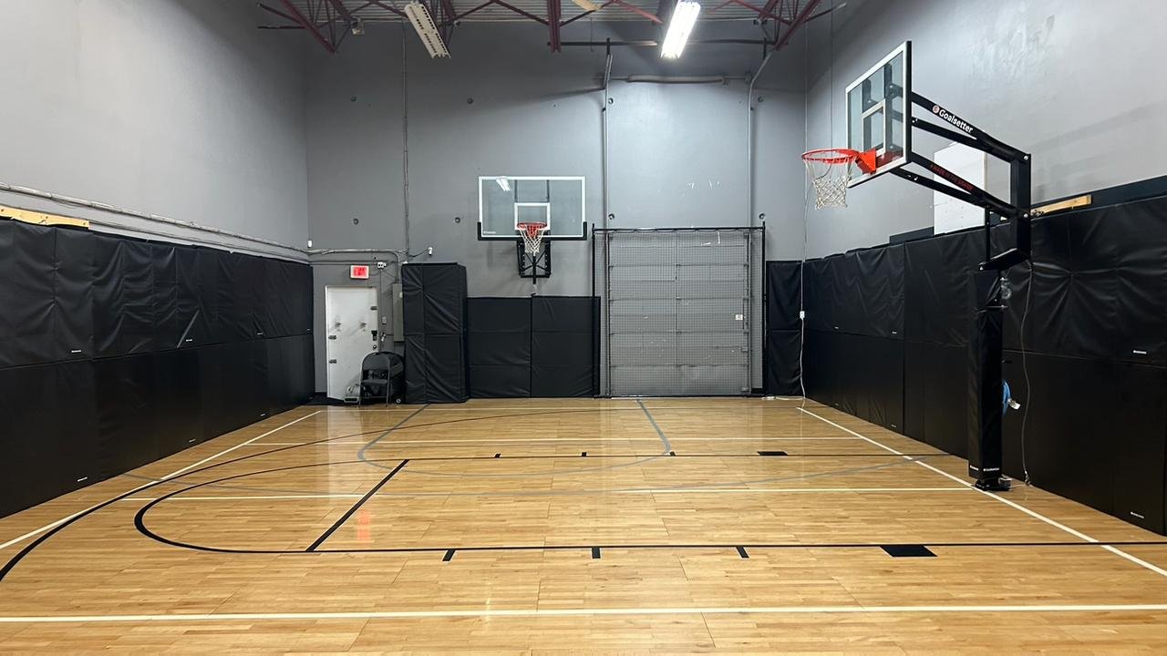 Legacy Basketball Club court - hardwood floor with two hoops