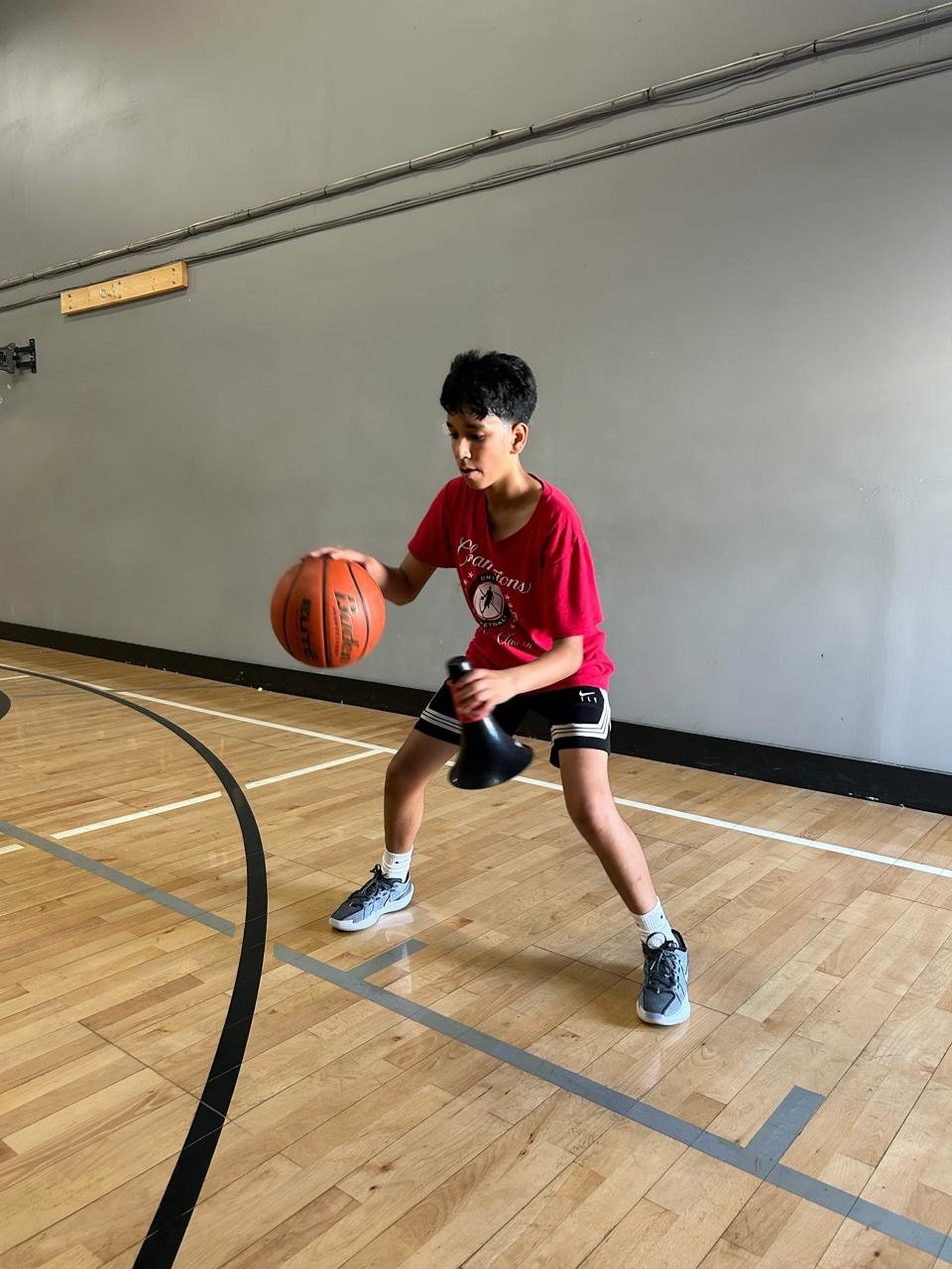 Youth player training with kettlebell dribbling drill